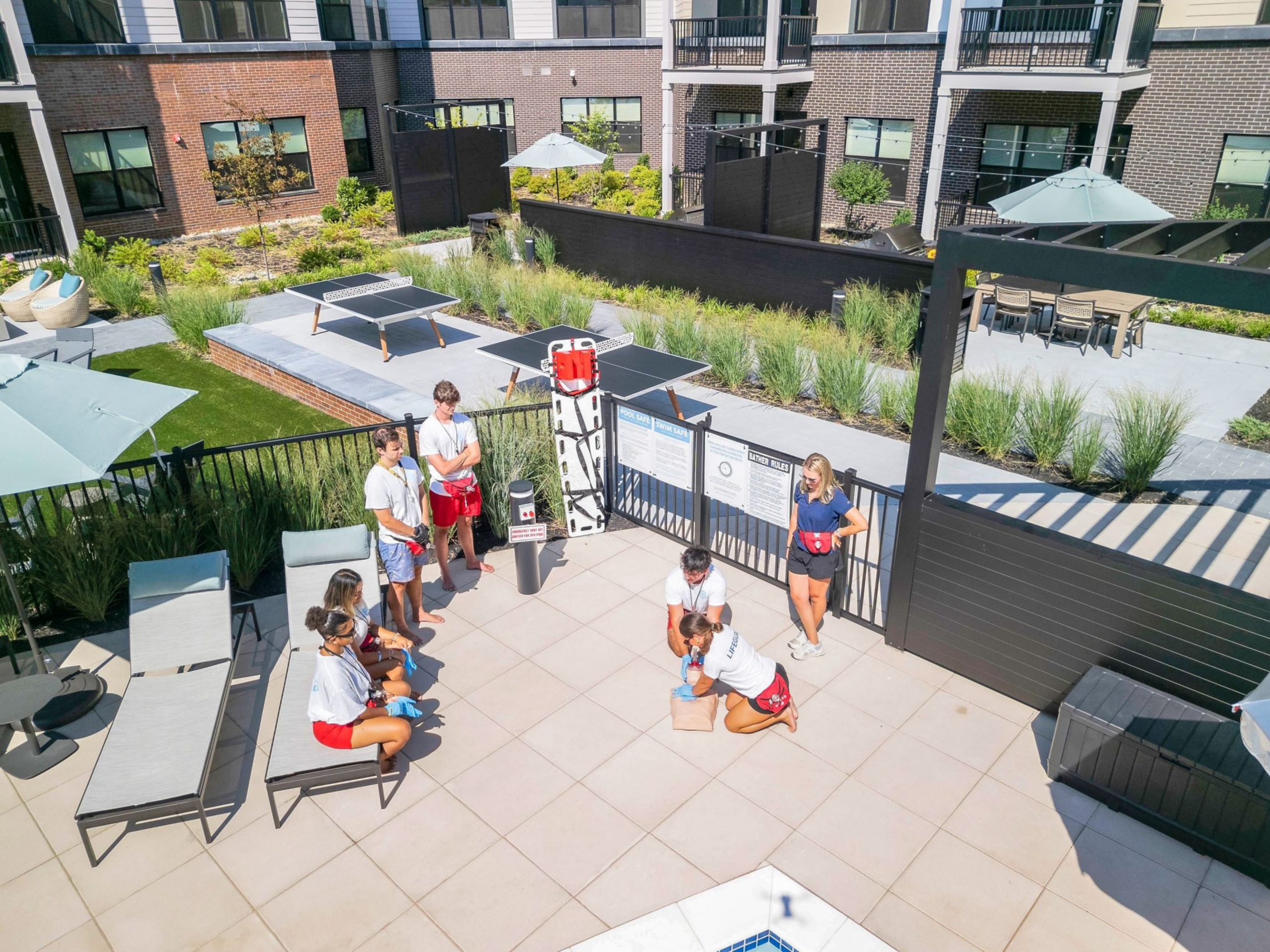 Group of lifeguards in training practicing CPR techniques